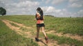 Young women active trail runners the top of a mountain in the afternoon, ultra marathon runners adventuring outdoors