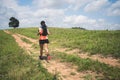 Young women active trail runners the top of a mountain in the afternoon, ultra marathon runners adventuring outdoors