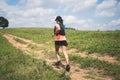 Young women active trail runners the top of a mountain in the afternoon, ultra marathon runners adventuring outdoors