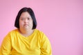 Young women with aphasia or Down syndrome She is a cerebral palsy student wearing a yellow dress on a pink background - Down