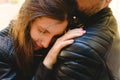 Young woman apologizing to her boyfriend leaning back and hugging her shoulders Royalty Free Stock Photo