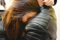 Young woman apologizing to her boyfriend leaning back and hugging her shoulders Royalty Free Stock Photo