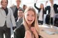 Young woman on the background of a jubilant business team.