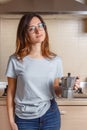 Young women stays in kitchen at home with coffee moka pot