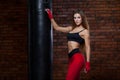 Young women boxing, the boxing bag. red bandage on hands Royalty Free Stock Photo