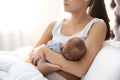 Young woman breastfeeding her baby in bedroom Royalty Free Stock Photo