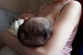 Young woman breastfeeding her baby at home. Milk from mother& x27;s breast is a natural medicine to baby. Mother day Royalty Free Stock Photo