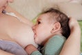 Young woman breastfeeding her baby at home. Milk from mother& x27;s breast is a natural medicine to baby. Mother day Royalty Free Stock Photo