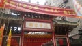 Shenzhen, China: young women burn incense and worship at the beidi temple