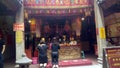Shenzhen, China: young women burn incense and worship at the beidi temple