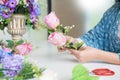 Young women business owner florist making or Arranging Artificial flowers vest in her shop, craft and hand made concept Royalty Free Stock Photo