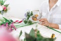 Young women business owner florist making or Arranging Artificial flowers vest in her shop, craft and hand made concept Royalty Free Stock Photo