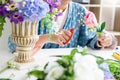Young women business owner florist making or Arranging Artificial flowers vest in her shop, craft and hand made concept Royalty Free Stock Photo
