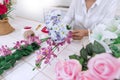 Young women business owner florist making or Arranging Artificial flowers vest in her shop, craft and hand made concept Royalty Free Stock Photo