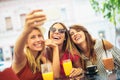Young women in a cafe after a shopping make selfie photo Royalty Free Stock Photo