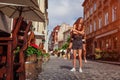 Young woman carrying her best friend on her back on city street. Happy girls laughing and having fun Royalty Free Stock Photo