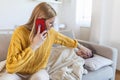 Young woman checking temperature with hand of little ill son. Mother calling a doctor for her sick boy Sick child lying on bed Royalty Free Stock Photo