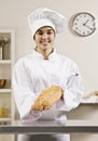 Young Women in chef's whites holding bread