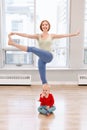 Woman with child boy son doing workout in gym class to loose baby weight. Royalty Free Stock Photo