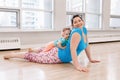 Woman with child daughter doing workout in gym class to loose baby weight Royalty Free Stock Photo