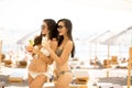 Young women with coctails on the beach Royalty Free Stock Photo