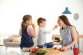 Young woman cooking breakfast for her children Royalty Free Stock Photo