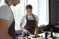 Young woman cooking in restaurant kitchen during cooking classes Royalty Free Stock Photo