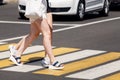 Young women crossing the road at a pedestrian crossing