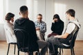 Young woman crying during widowers support group meeting Royalty Free Stock Photo