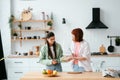 Two girlfriends cut fruit in the kitchen Royalty Free Stock Photo