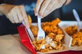 Young women cutting crispy fried chicken wings and crispy chicken legs in restaurants