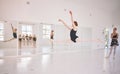 Young woman dance instructor teaching a ballet class to a group of a children in her studio. Ballerina teacher working Royalty Free Stock Photo