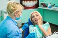 Young woman at the dentist complaining about a toothache. Dentistry. Doctor and the patient