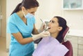 Dentist examining patients teeth and doing checkup in clinic Royalty Free Stock Photo