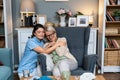 Young woman doctor health care worker medic nurse comforting older senior woman at home visit, patient suffering from clinical Royalty Free Stock Photo