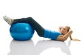 Young women doing crunches on fitness ball