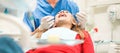 Young woman doing a dental treatment inside professional dentist studio - People bodycare and stomatology concept for healthy