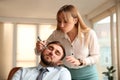 Young woman drawing on colleague`s face while he sleeping in office. Funny joke Royalty Free Stock Photo
