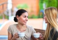 Young women drinking coffee in a cafe outdoors