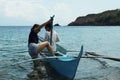 Young women enjoy riding on tiny small boat on sea