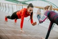 Young woman exercising with a personal trainer outside Royalty Free Stock Photo