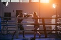 Woman exercising with trainer at boxe and self defense lesson. Copy space