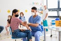 Woman with face mask getting vaccinated, coronavirus, covid-19 and vaccination concept.