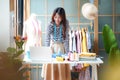 Young women fashion designer using laptop working and design tailor and cloth in the showroom, Royalty Free Stock Photo