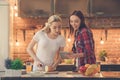 Young women friends cooking meal together at home Royalty Free Stock Photo