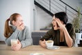 Young women friends offended in cafe while drinking coffee Royalty Free Stock Photo