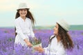 Young woman and girl are in the lavender field, beautiful summer landscape with red poppy flowers Royalty Free Stock Photo