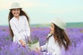 Young woman and girl are in the lavender field, beautiful summer landscape with red poppy flowers Royalty Free Stock Photo