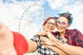 Young women girlfriends taking selfie at ferris wheel on public Royalty Free Stock Photo