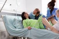 Young woman giving birth and pushing in hospital ward bed Royalty Free Stock Photo